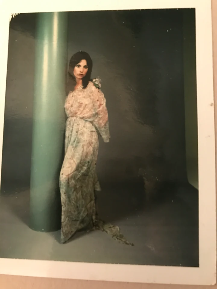 Denise McCann posing in a floral gown during a portrait test
